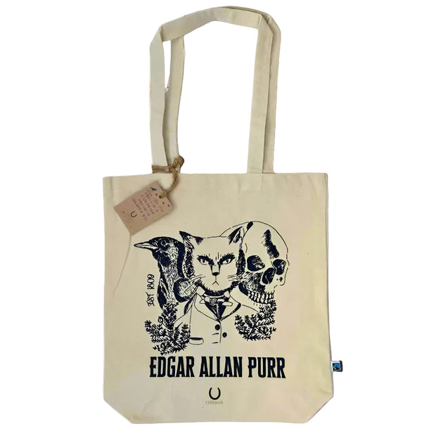 Beige tote bag with a cat and bird design and 'Edgar Allan Purr' text on a white surface
