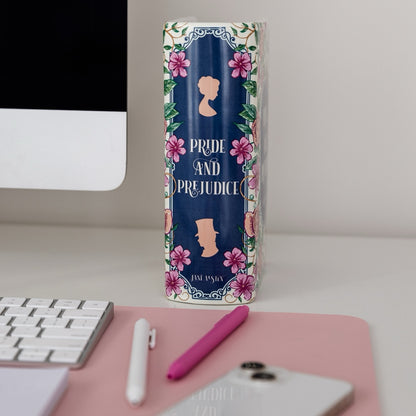 Book shaped vase with 'Pride and Prejudice' cover on a desk with computer and phone