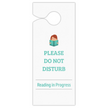 A white hanging door sign with a small cartoon illustration of a person reading, above the text 'PLEASE DO NOT DISTURB' and 'Reading in Progress' in teal, shown on a plain white background.
