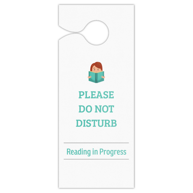 A white hanging door sign with a small cartoon illustration of a person reading, above the text 'PLEASE DO NOT DISTURB' and 'Reading in Progress' in teal, shown on a plain white background.