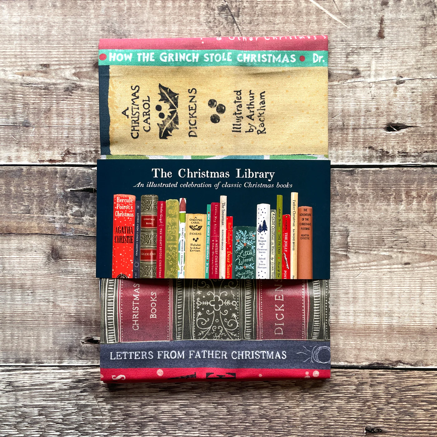 Collection of Christmas-themed books on a tea towel