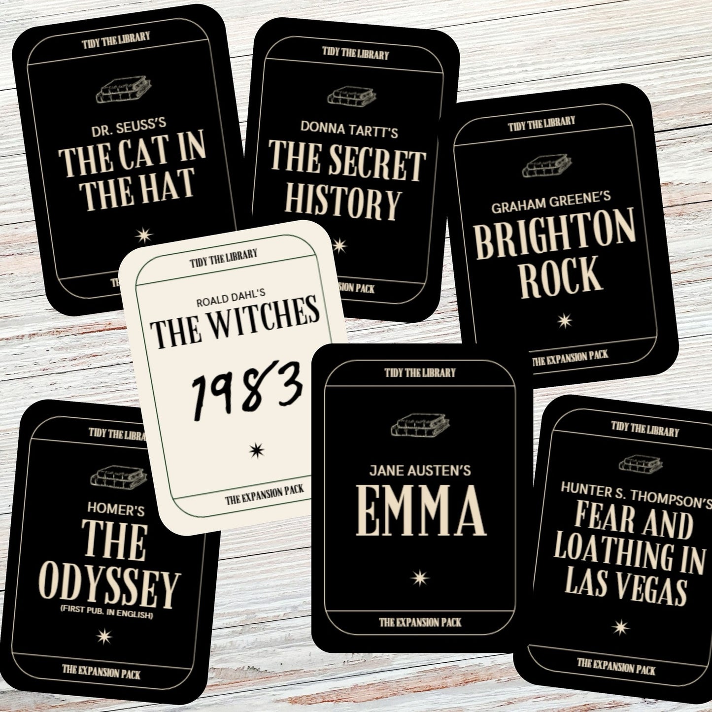 Collection of book-themed cards on a wooden surface
